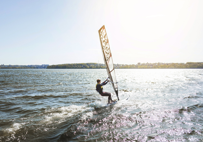 Kitesurfista deslizándose sobre las aguas del Estrecho de Gibraltar en Tarifa con el viento atlántico de fondo